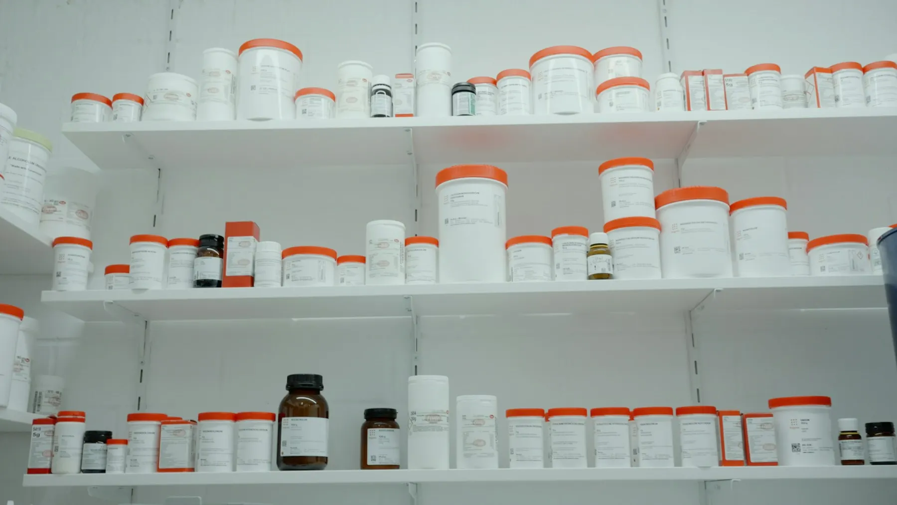 Pharmaceutical containers arranged on storage shelves